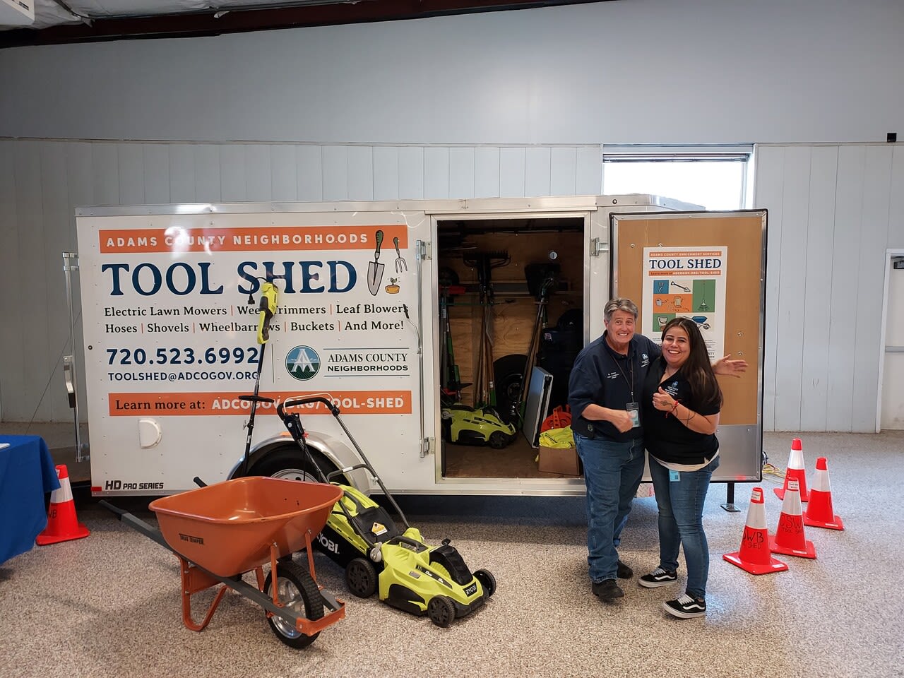 Staff standing next to the Adams County Tool Shed.
