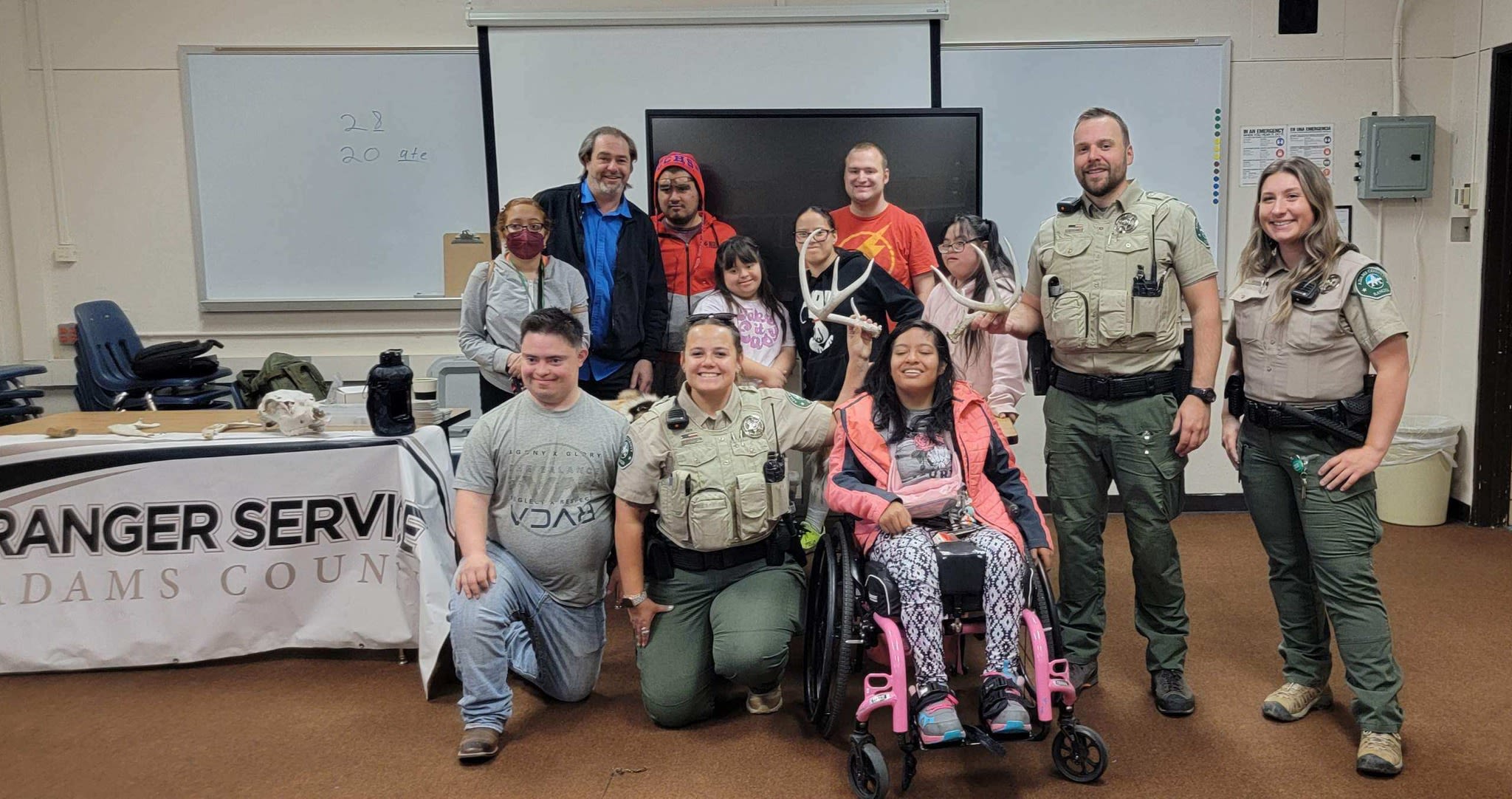 Park rangers smiling alongside young people in the Transition Program.
