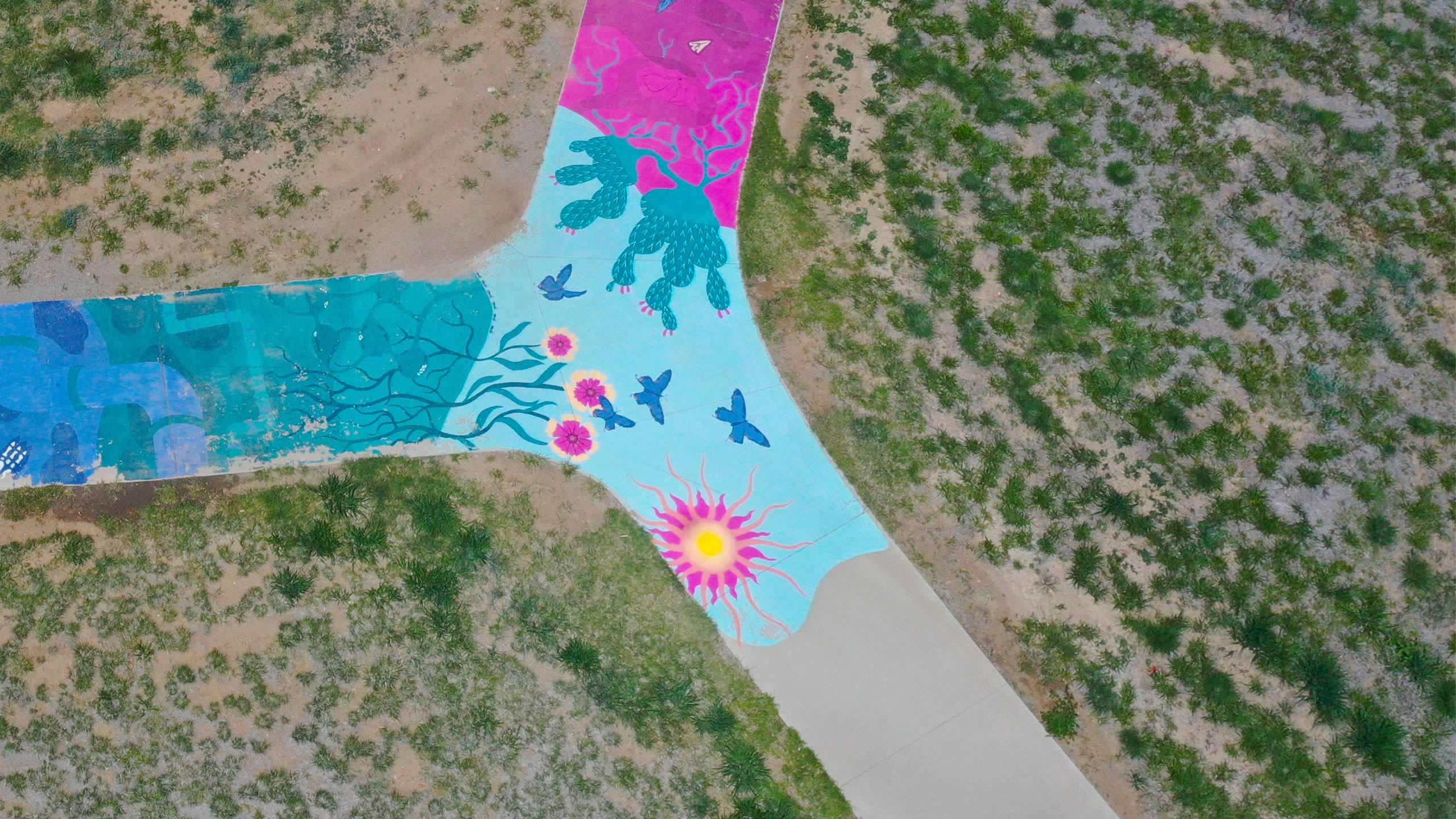 Public art spanning the sidewalk at an Adams County park.