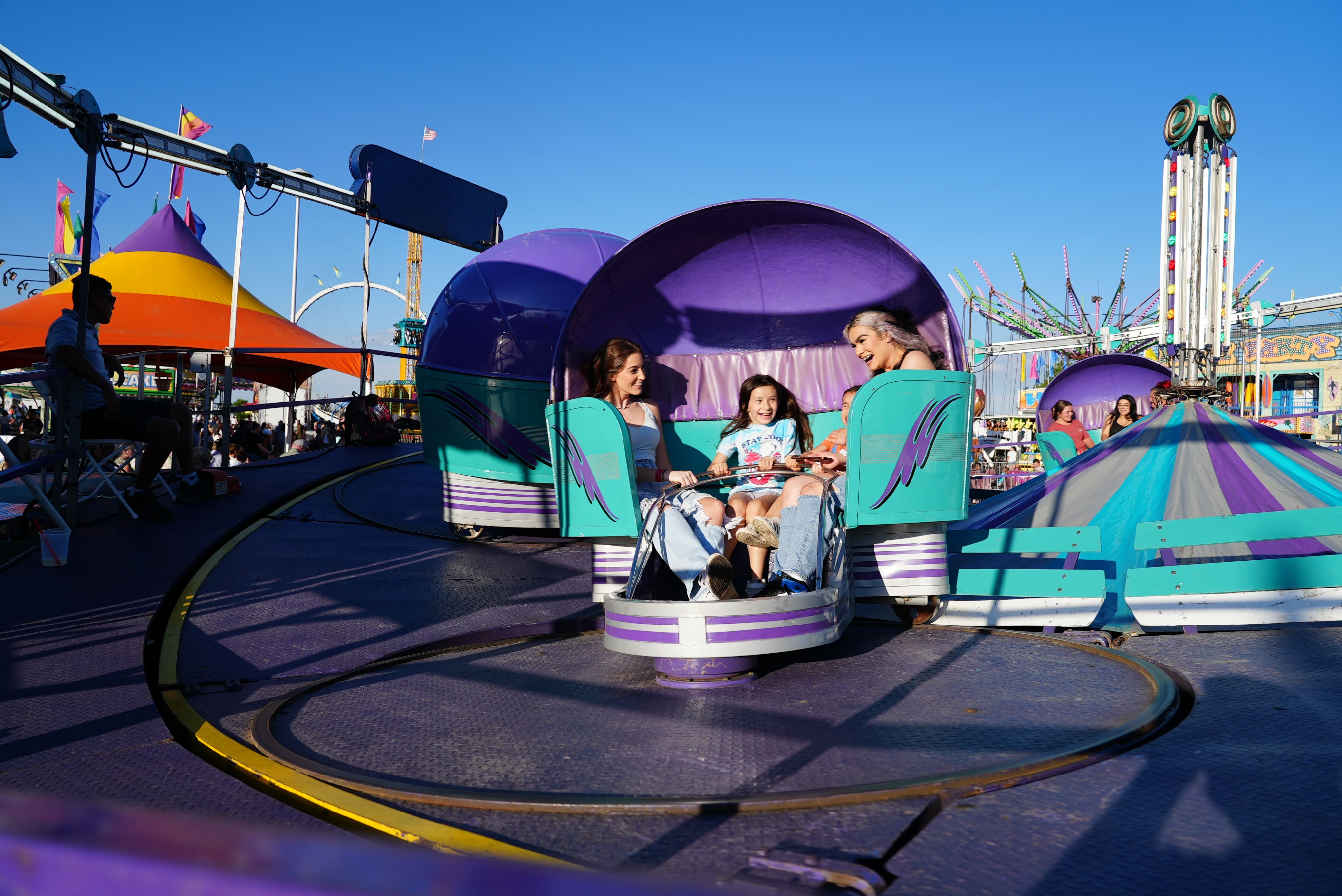Families riding one of the carnival rides at the Adams County Fair.