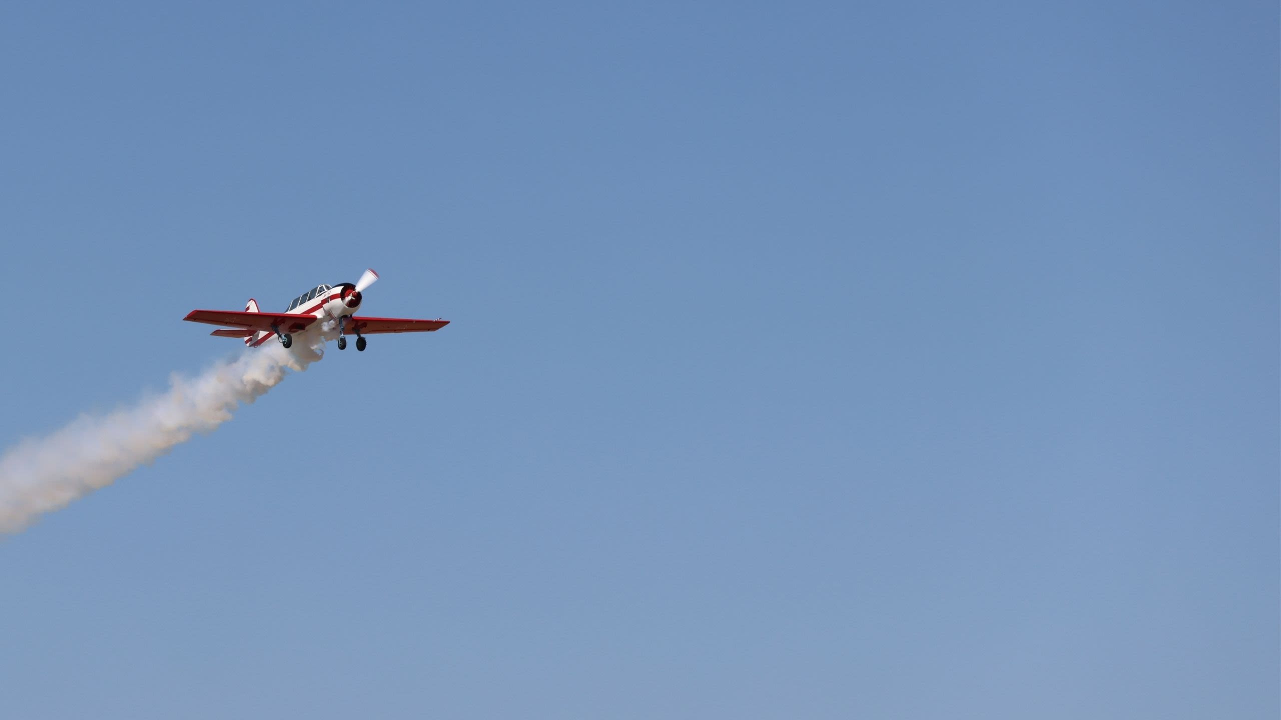 A prop plan flying through blue skies over the Colorado Air and Space Port