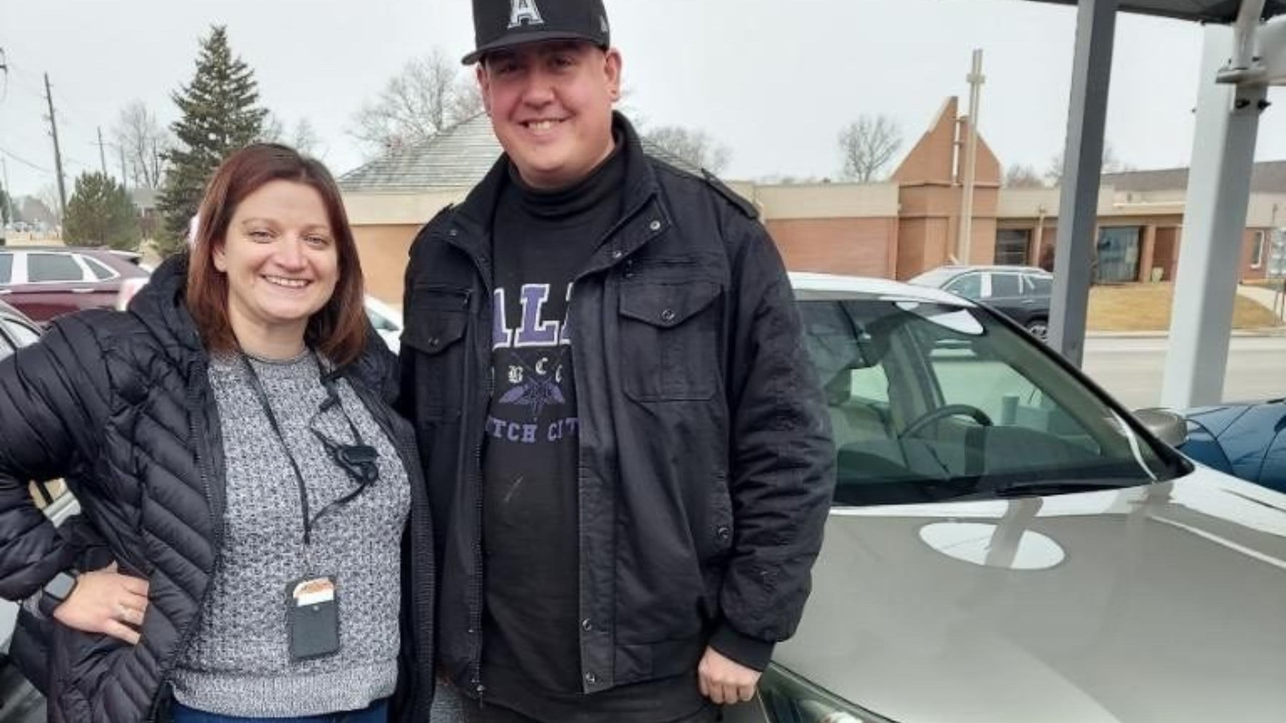 Navy veteran Matt standing with Adams County staff and his new vehicle.