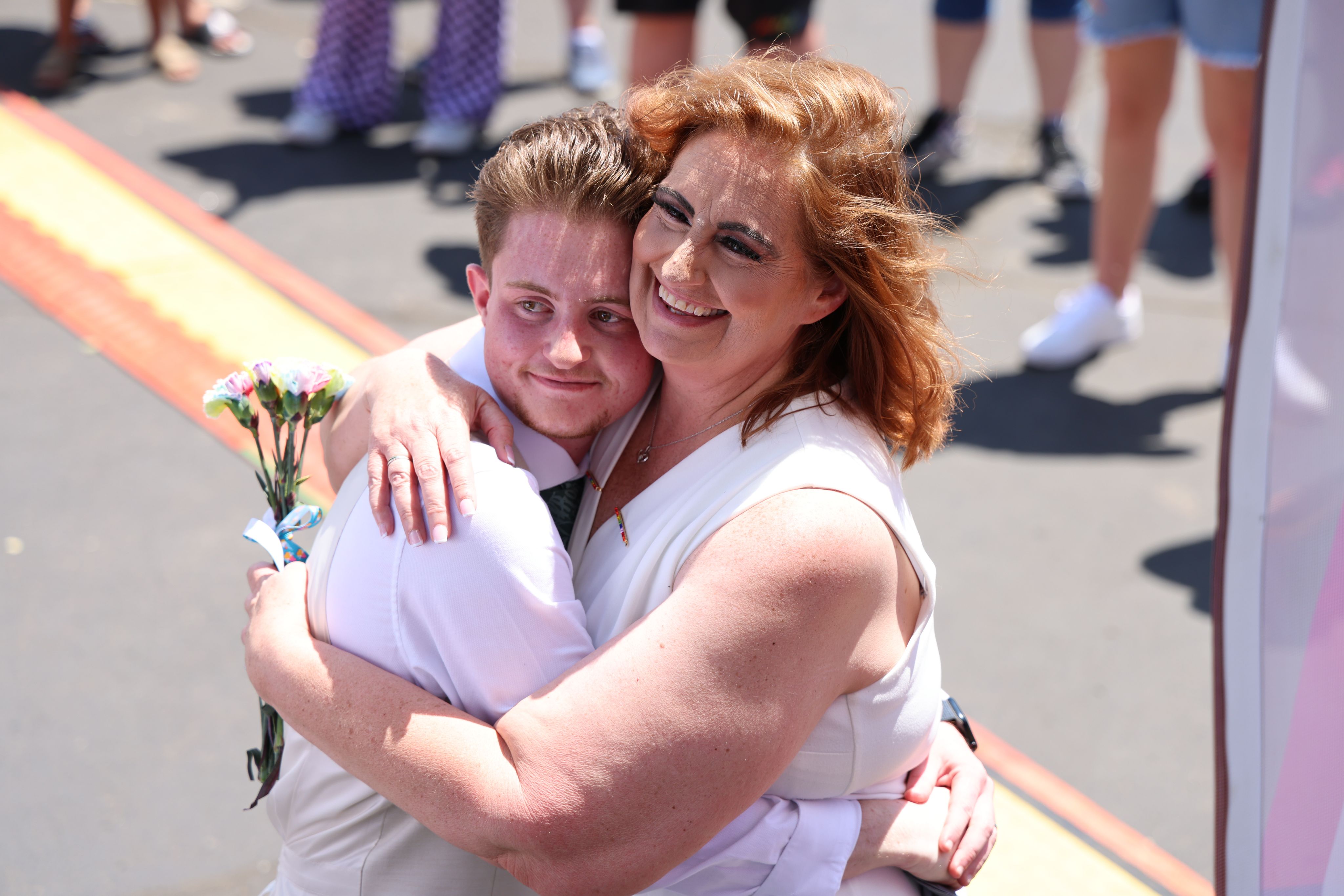 A couple smiling and hugging during Adams County Pride.
