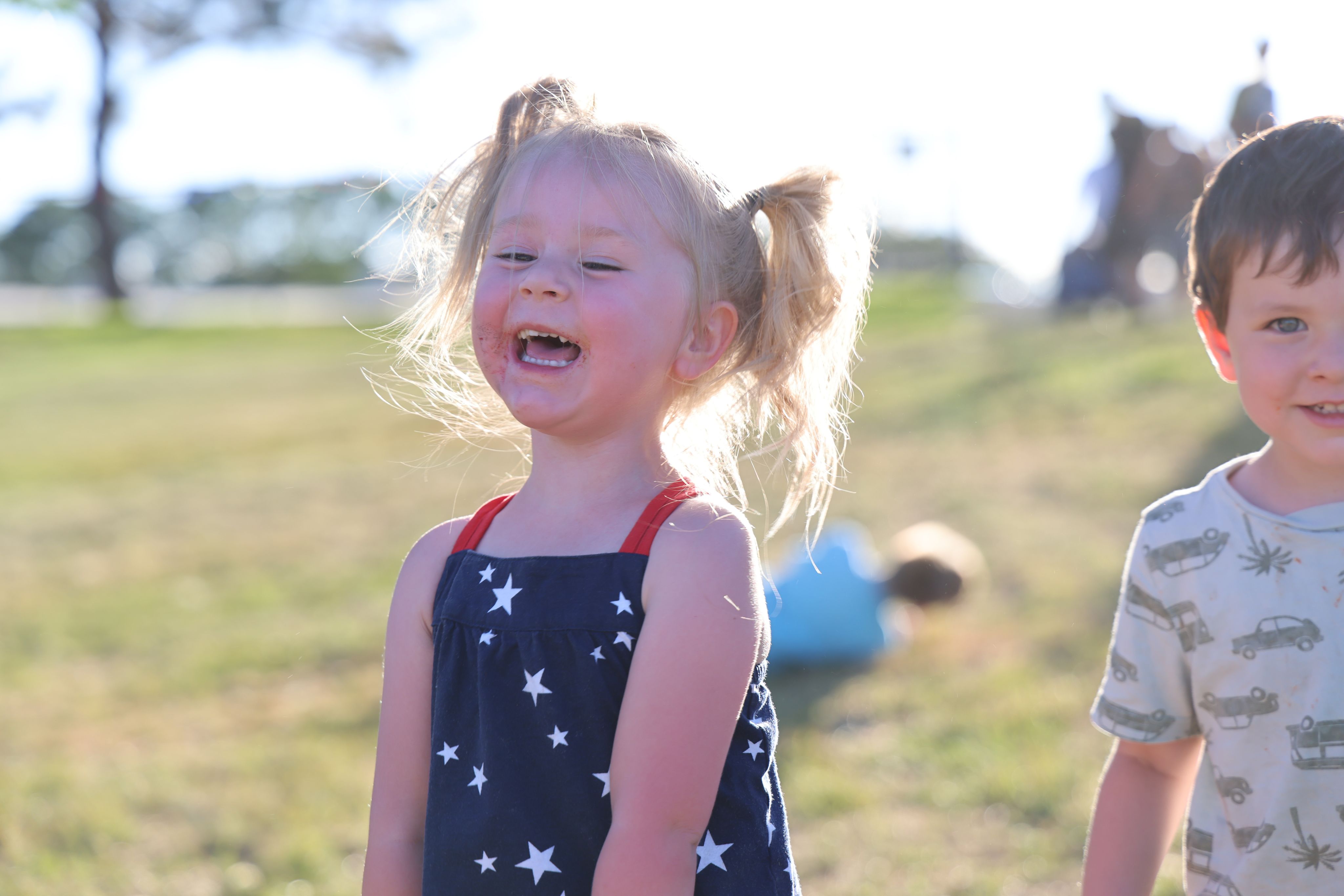 A child laughing at the Adams County Stars & Stripes event.