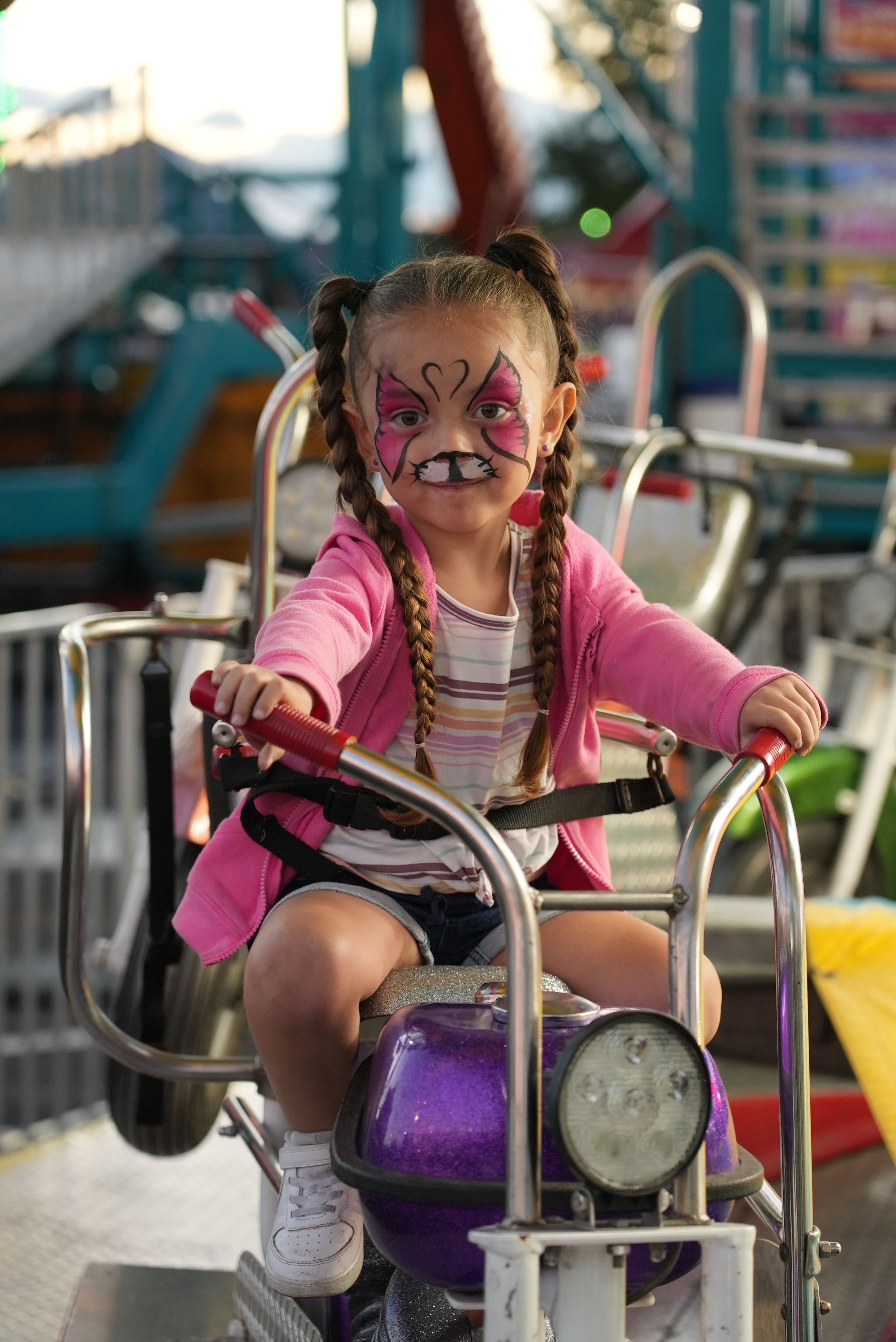 A child riding a carnival ride at the Adams County Fair.